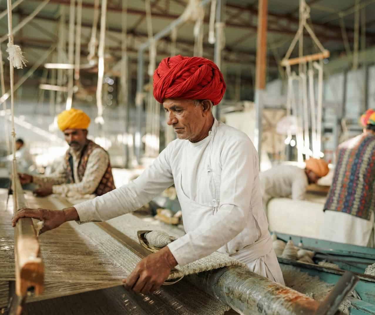 Artisan weaving on a traditional loom at Pure Loom